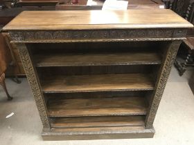 A carved oak open bookcase. Dimensions 30x106x114c