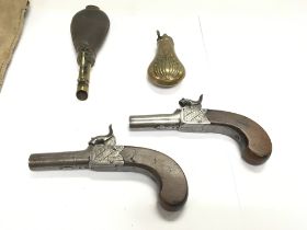 A pair of English percussion cap pistols with waln