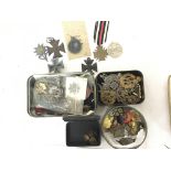 A collection of military badges and medals compris