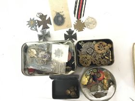A collection of military badges and medals compris