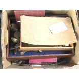A box containing mixed cutlery and a box containin