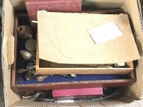 A box containing mixed cutlery and a box containin