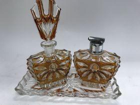 A Art Deco glass perfume bottle with matching atom