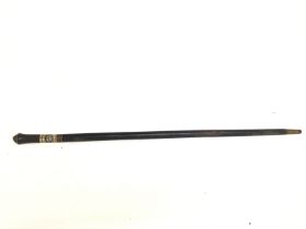 A vintage ebonised Indian sword stick with carved