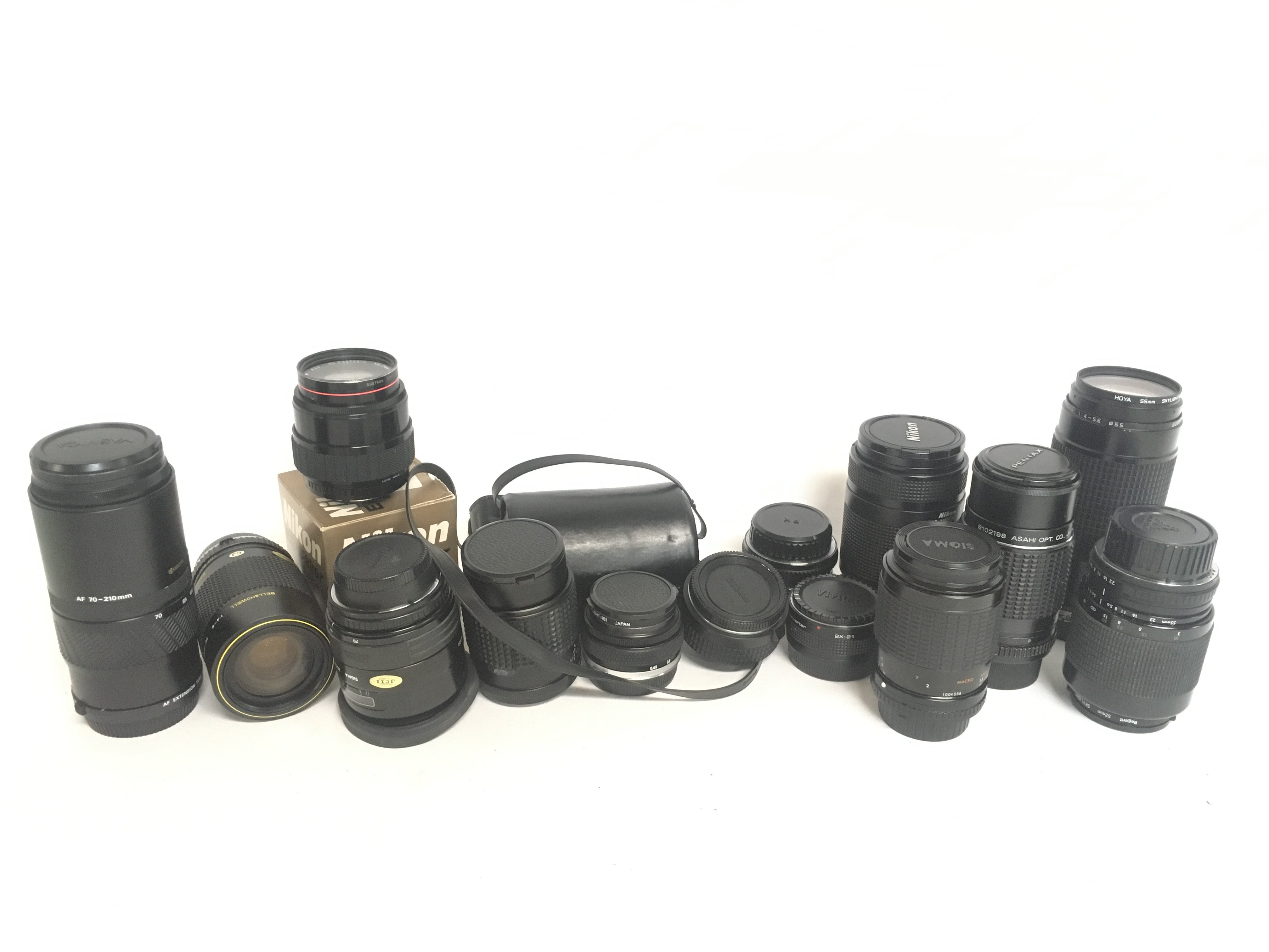 A collection of camera lenses including a Yashica