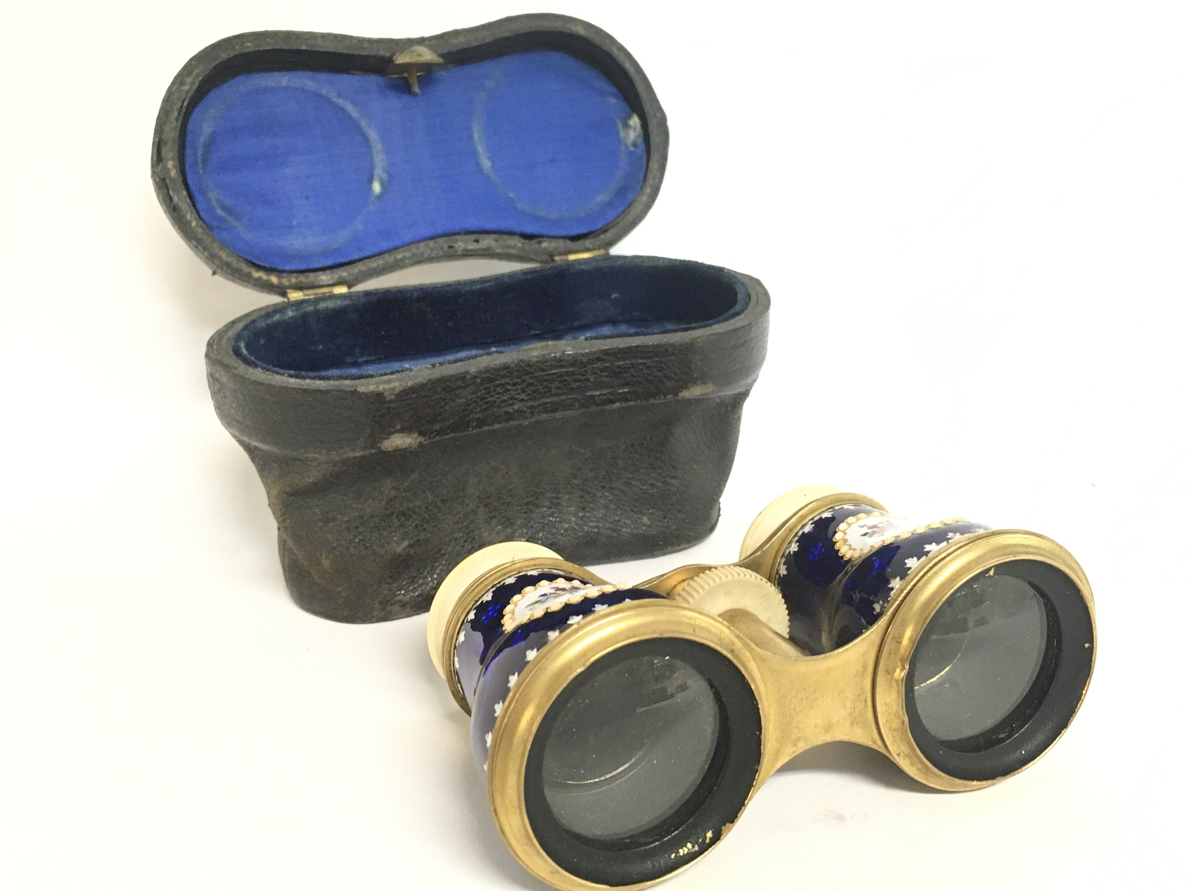 A cased pair of enamel opera glasses. This lot can