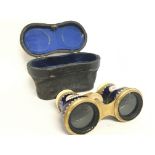 A cased pair of enamel opera glasses. This lot can