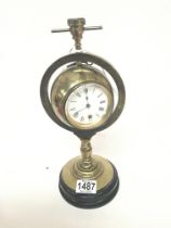 A brass compass clock the case within a brass gimb