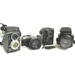 Vintage cameras including a Rolleicord, Olympus OM