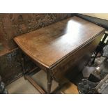 A George III drop leaf dining table. Dimensions 53