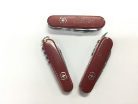 Three Swiss Army knives. Shipping category A.
