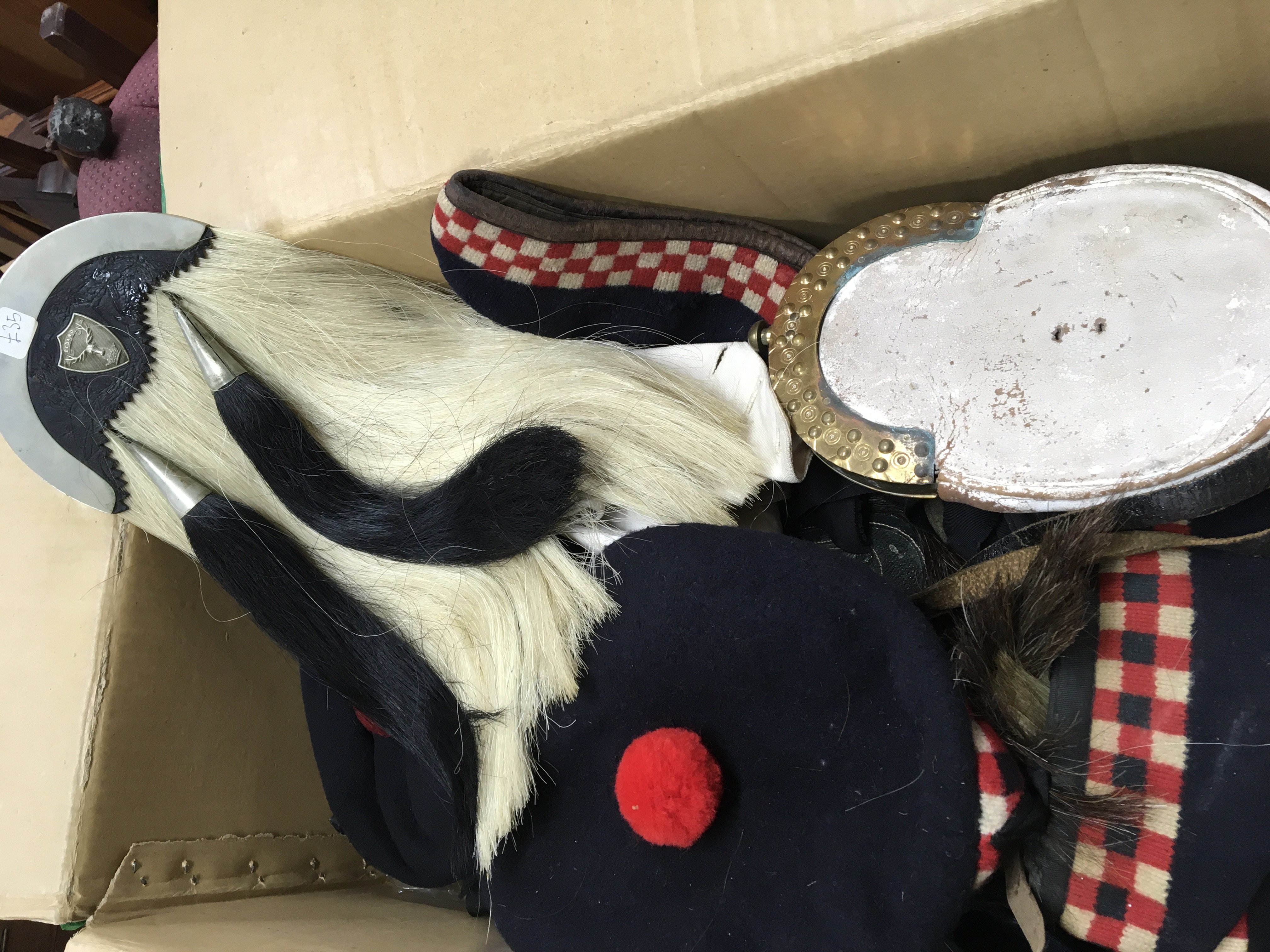 A box containing Scottish Military hats sporrans g