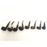 A collection of vintage smoking pipes one with a s