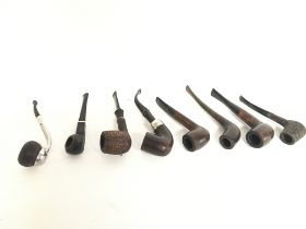 A collection of vintage smoking pipes including a