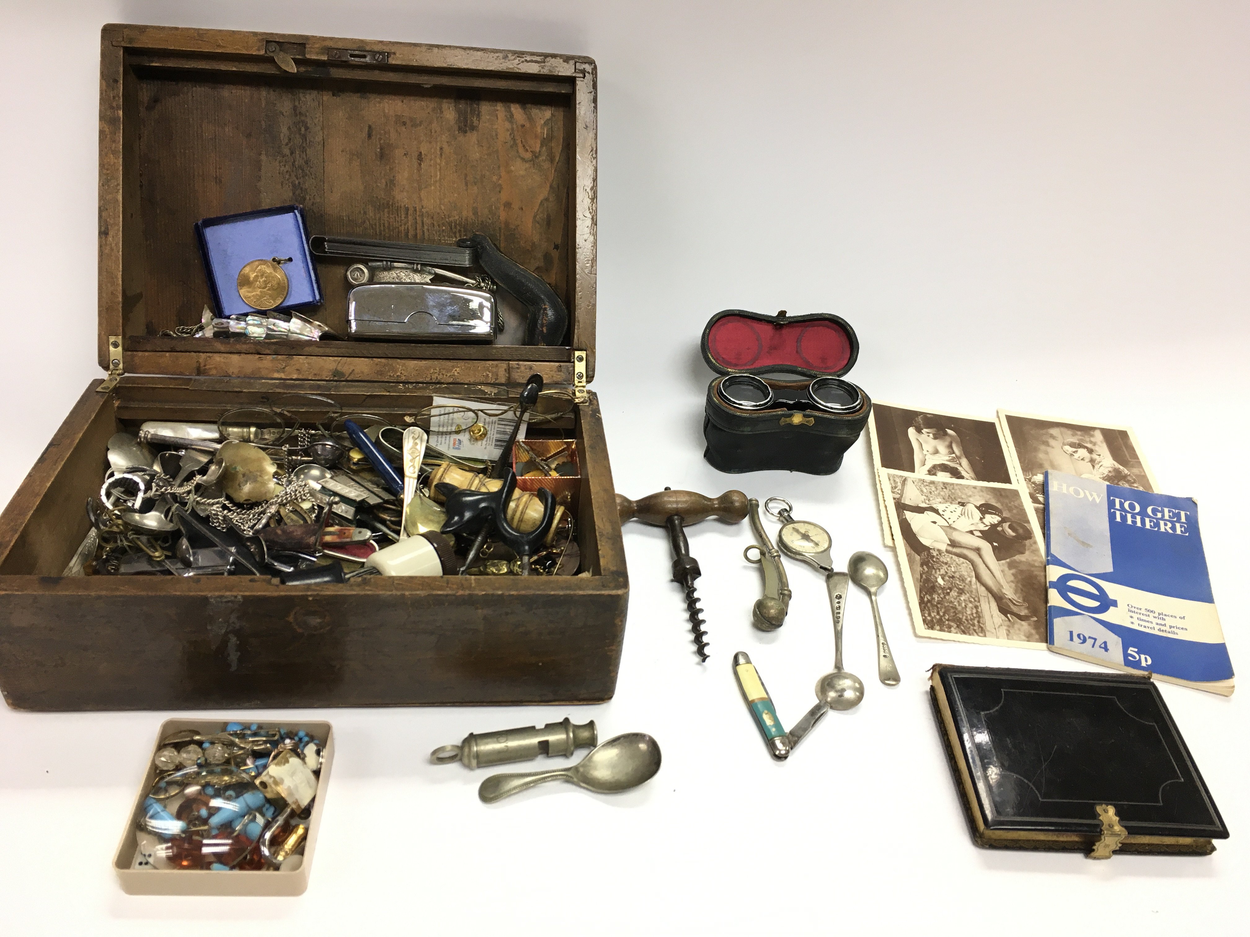 A box of interest items including whistles spoons