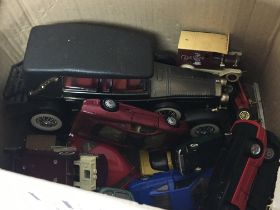A box containing die cast model vehicles unboxed.
