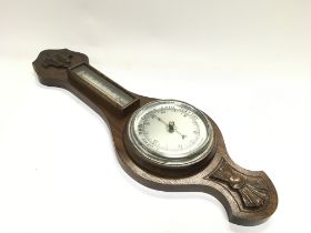 An oak barometer. 58cm