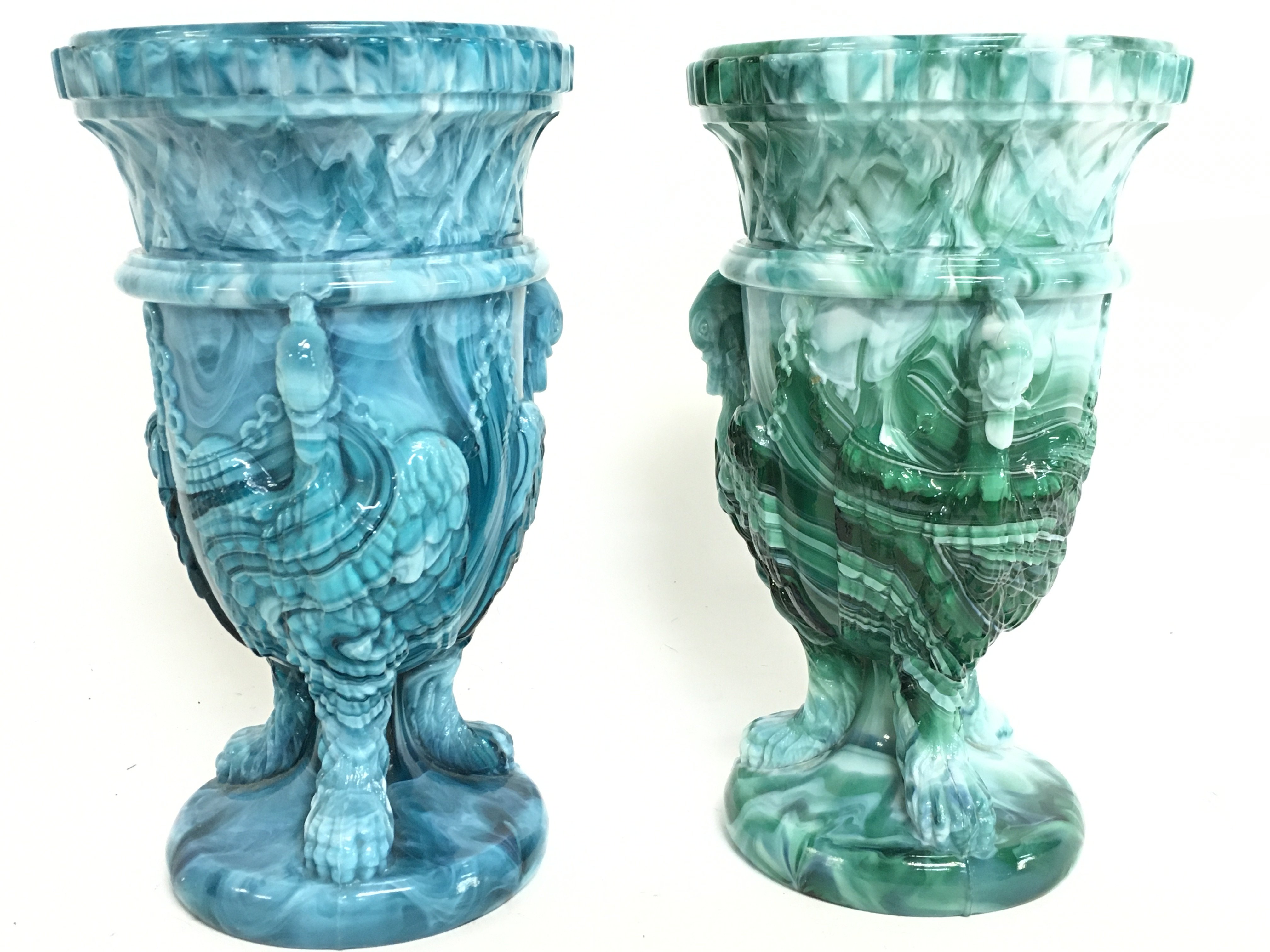 A pair of malachite slag Gryphon glass urns, 17cm