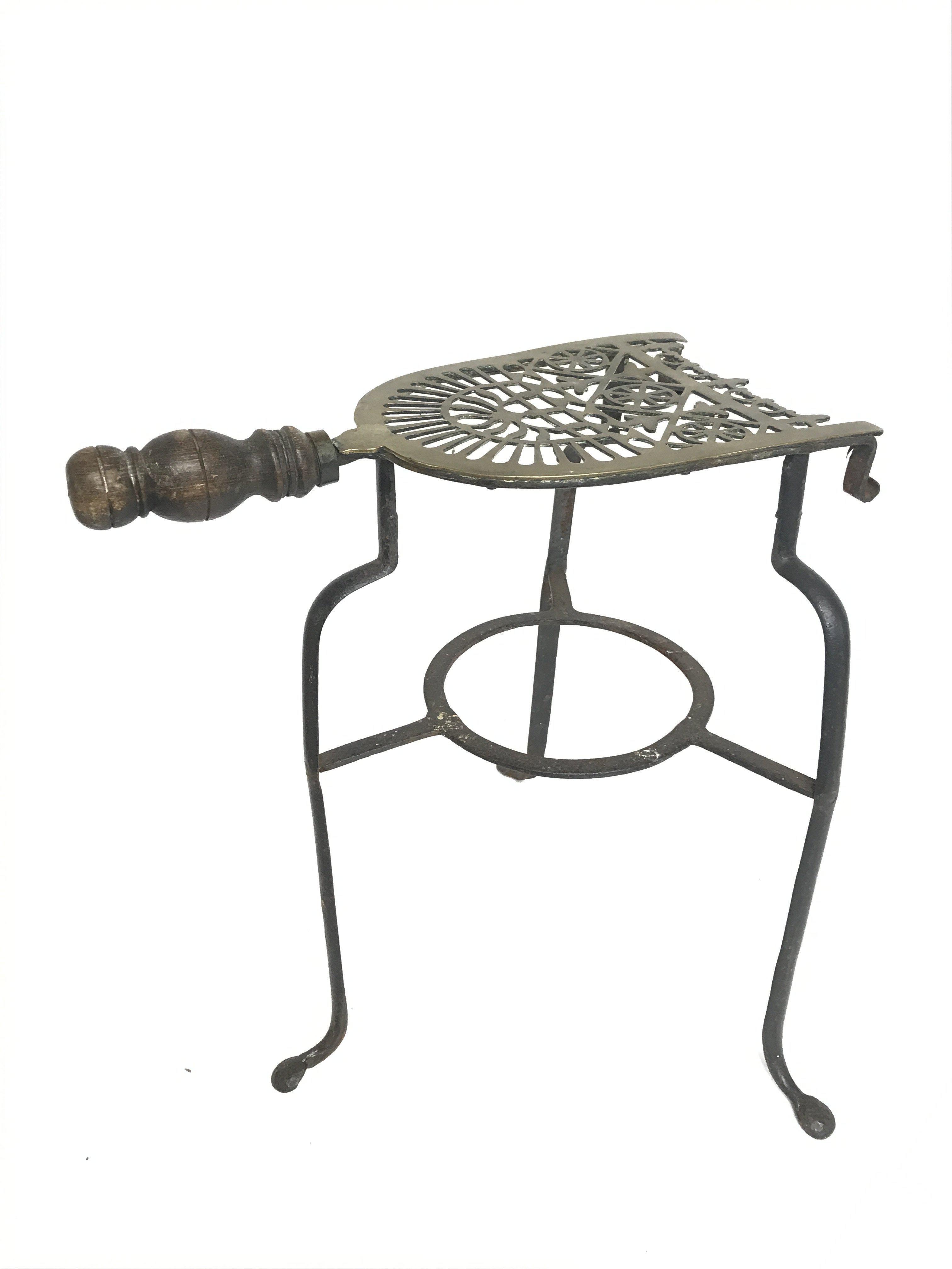 A Victorian large brass and iron trivet. 36cm tall