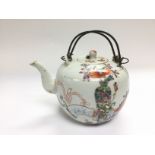 An Oriental teapot with hand painted decoration, a