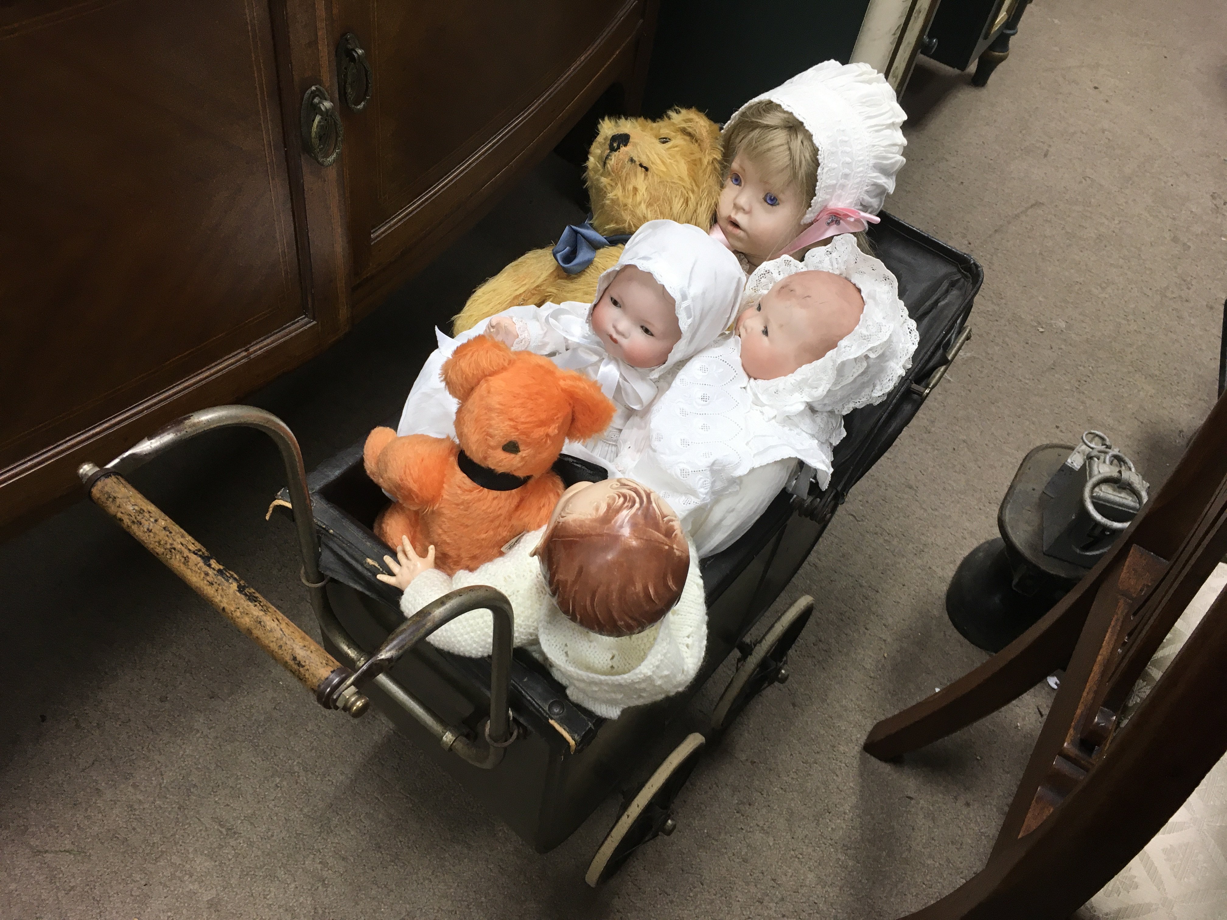 A early 20th century pram with an assortment of vi