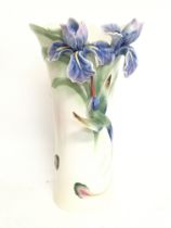 A Franz porcelain humming bird with blue orchids v