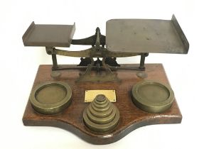 A set of brass office beam balance scales with a s