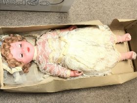 A boxed vintage mid 20th century doll. Postage cat