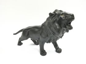 A bronze lion. Approximately 39cm wide by 22cm hig