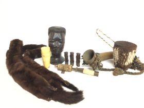 A collection of items including a tribal wooden ca