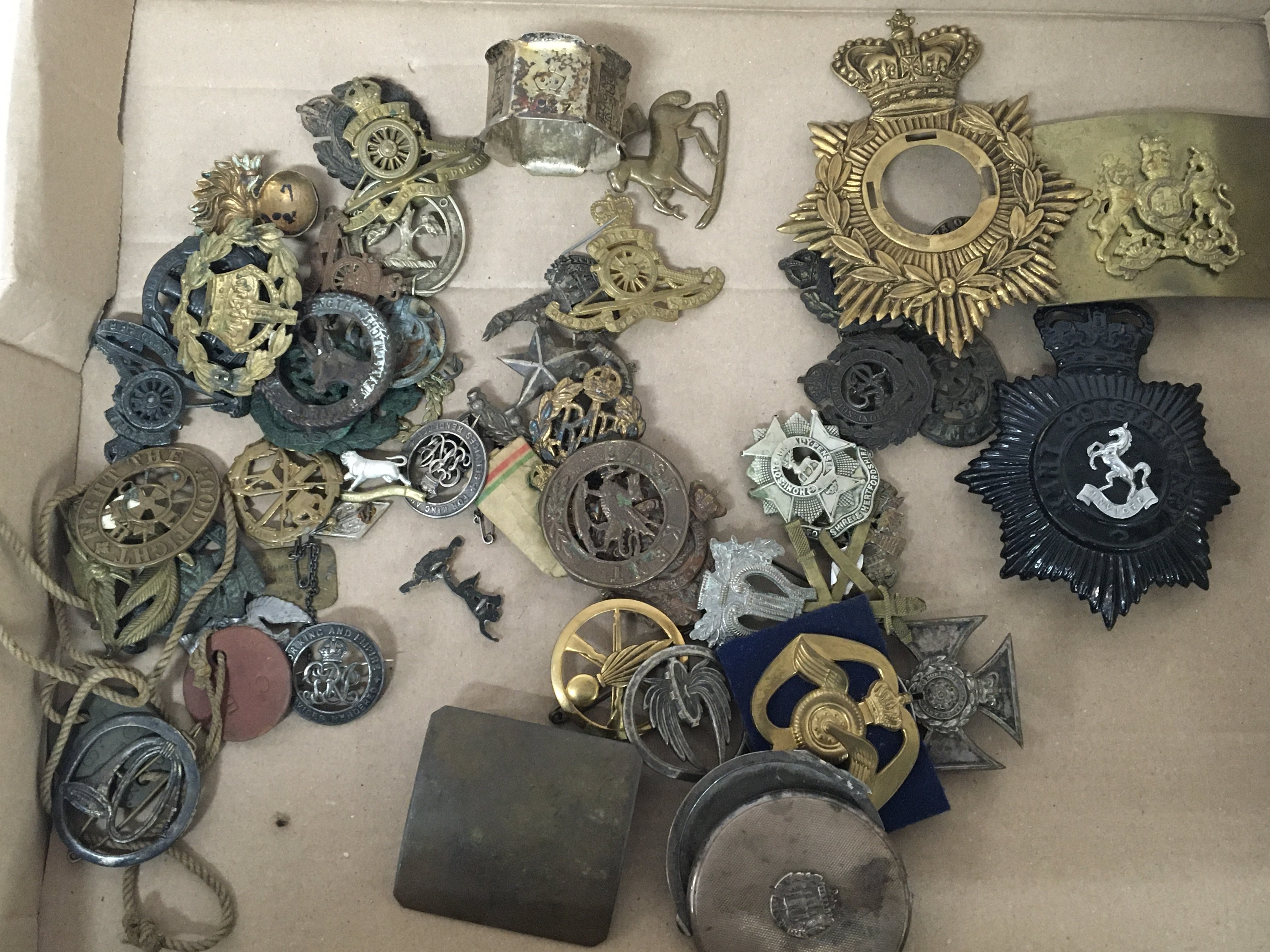 A collection of military badges belt buckles shako