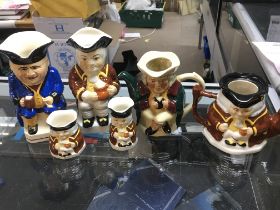 A collection of porcelain character jugs including