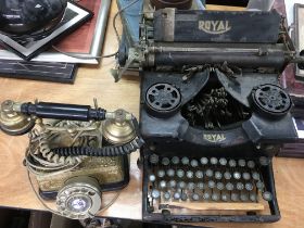 A vintage Royal typewriter and a telephone. This l