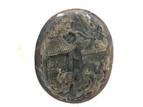 A Chinese carved tortoiseshell panel, 3cm tall. Po