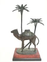A bronze camel figure mounted on a wooden base, 42