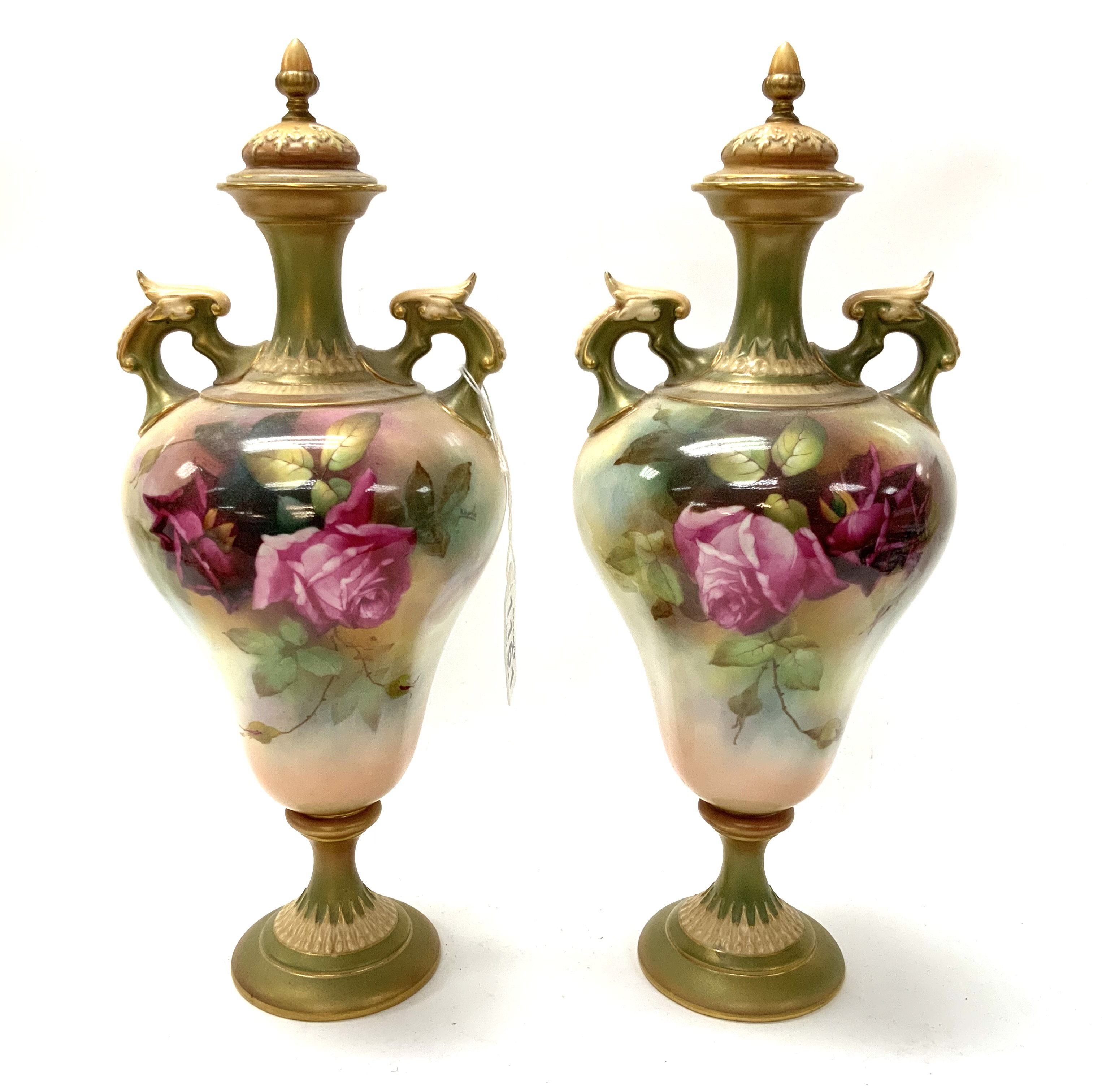 A Pair of Royal Worcester hand painted urns and co