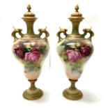 A Pair of Royal Worcester hand painted urns and co