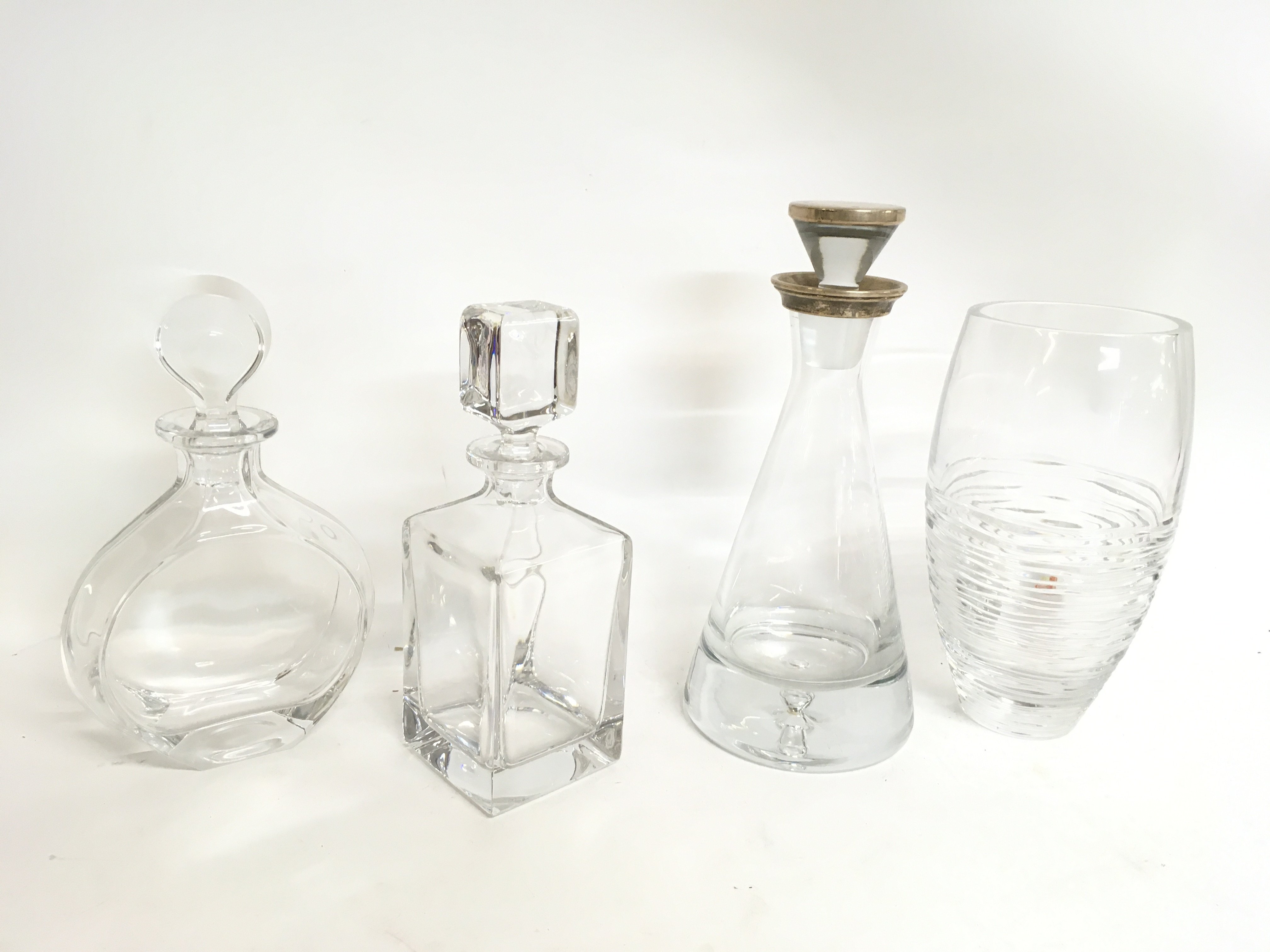 A collection of decanters including one with a sil