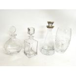A collection of decanters including one with a sil