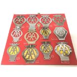 A mounted collection of twelve vintage AA badges f