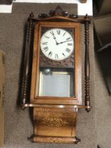 An inlaid walnut wall clock, dimensions 15x82x40cm