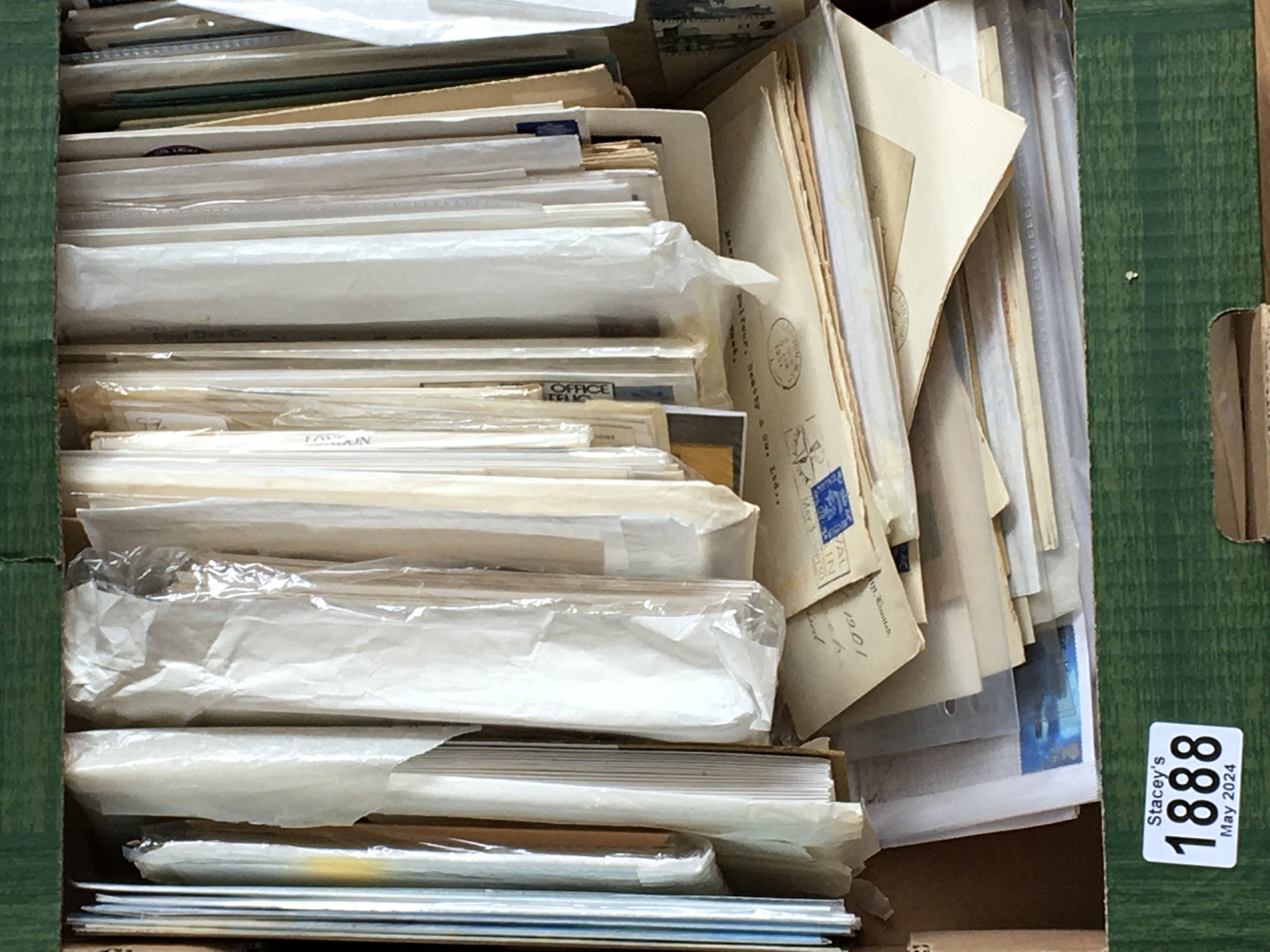 A box containing stamp covers and envelopes