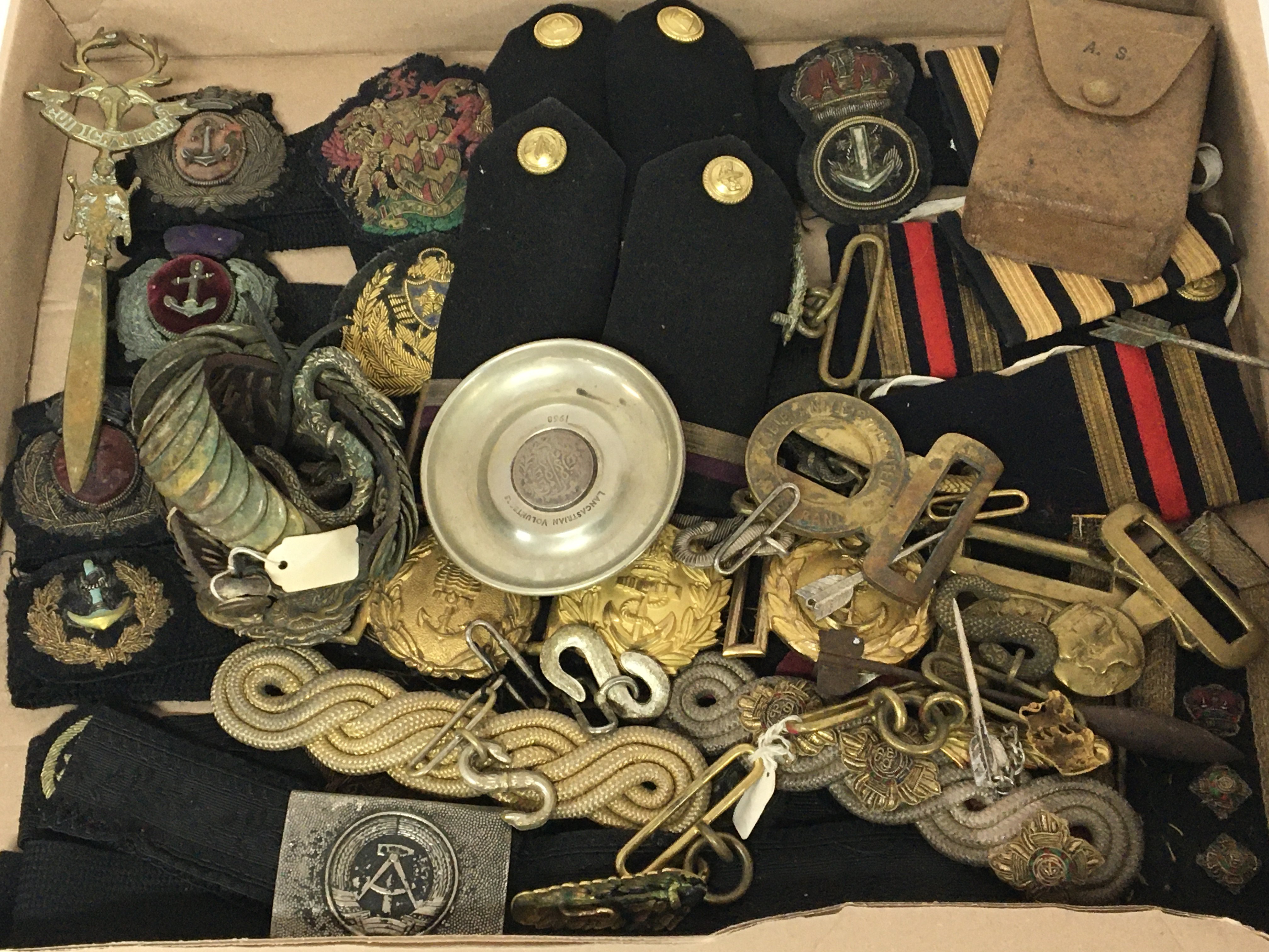 A collection of Royal Navy cloth badges epaulets a