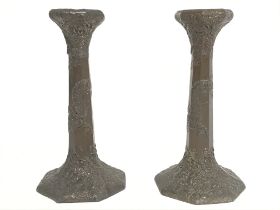 A pair of Japanese metal candlesticks decorated wi