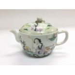 A small teapot wit hand painted decoration of a ge