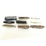 A collection of pocket knives and multi tools. Thi