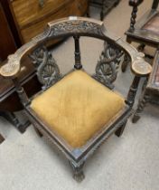 A late Victorian carved oak corner chair. (D)