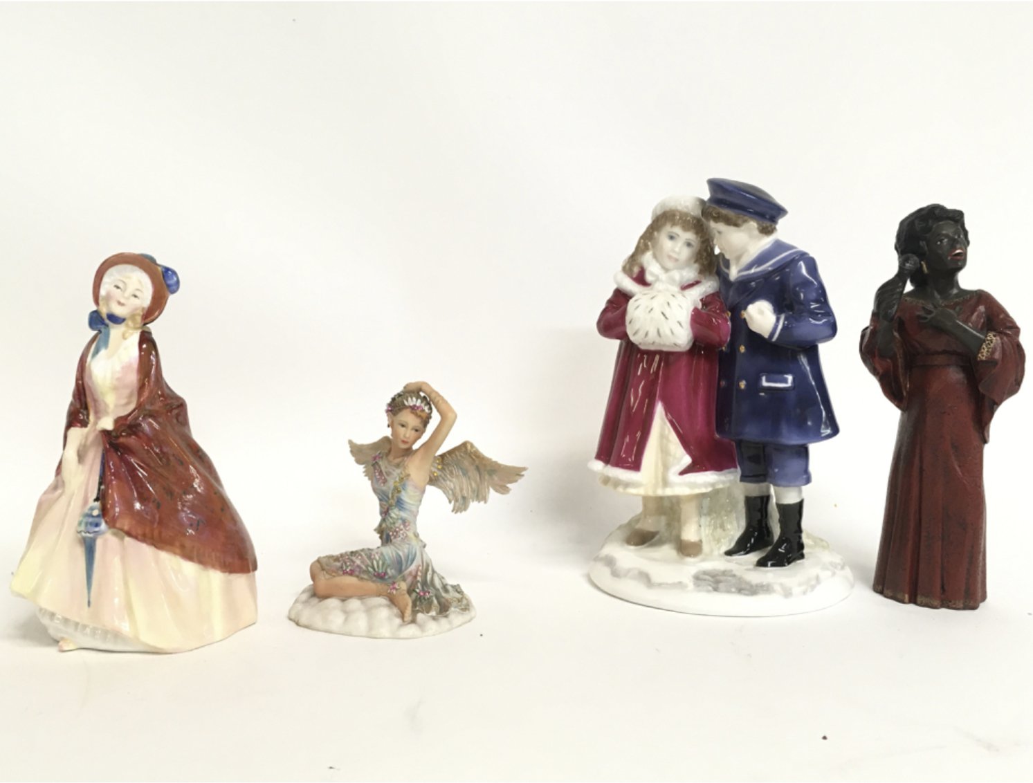 A collection of porcelain figures including a limi