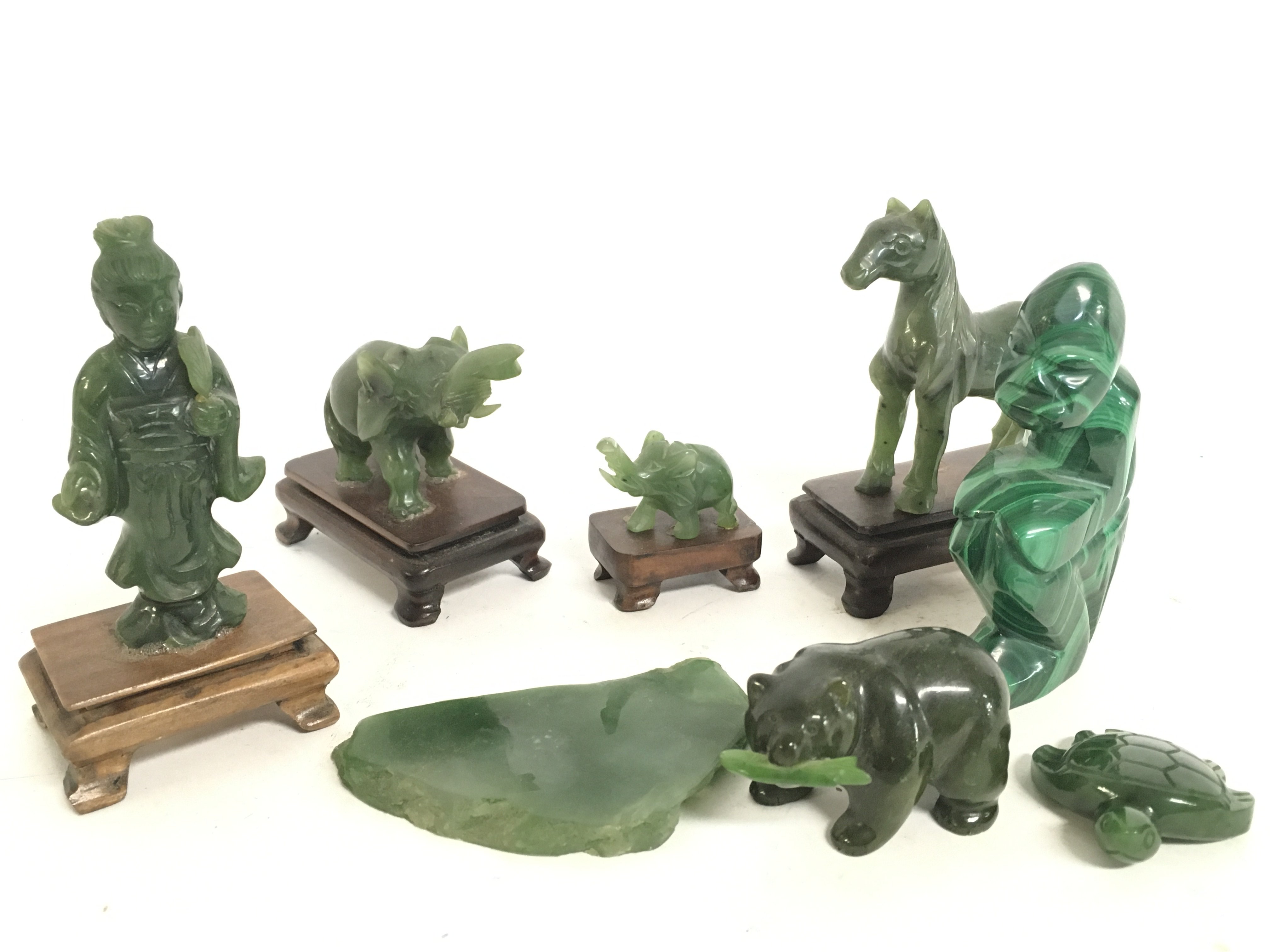 A collection of small Chinese jade figures including various animals, a ...