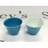 Two rice wine cups in blue, one with a white inter